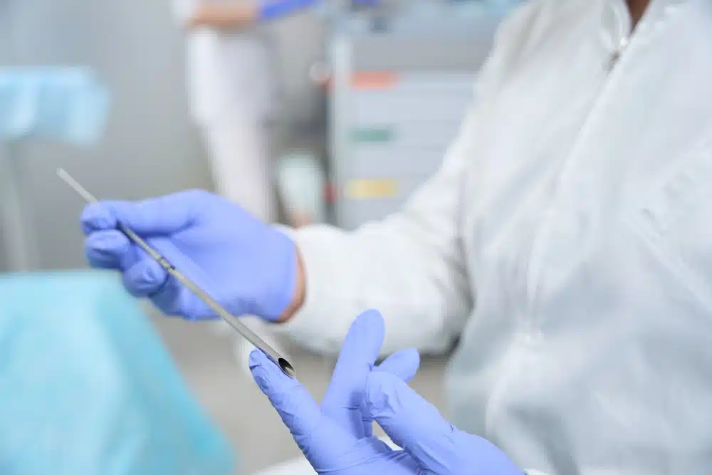 doctor,holds,in,his,hands,tool,for,installation,of,bioidentical